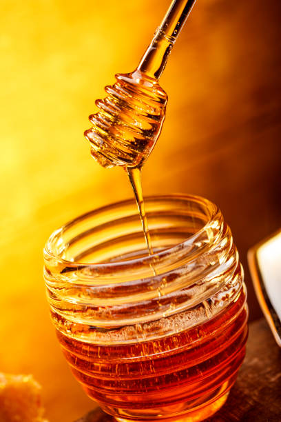 istock Honey pot on wooden background 1146488965