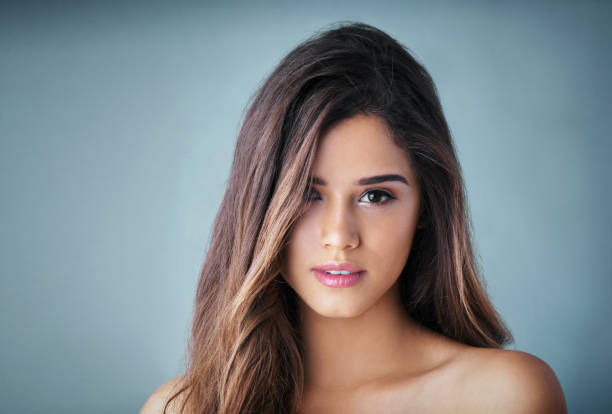 studio portrait of a girl on a black background closeup