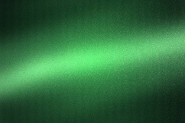 istock Light shining on green metallic plate in dark room, abstract texture background 1146491580