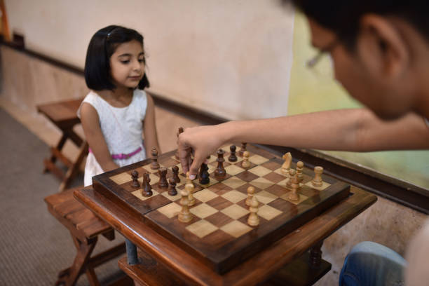 istock Brother and sister playing Chess 1146492130