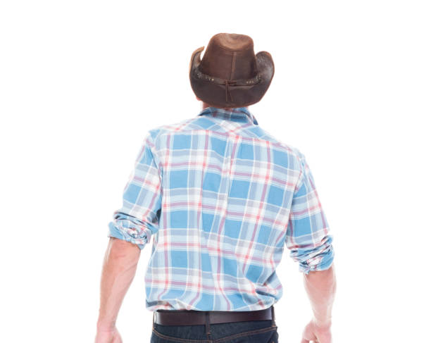 istock Handsome cowboy is walking, rear view 1146493413