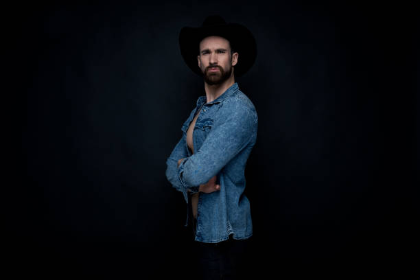 istock Handsome sexy cowboy on black background 1146493792