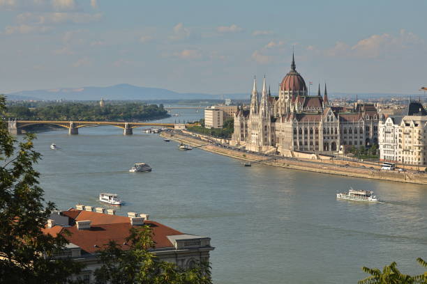 Danube River and Hungarian Parliament Building, Budapest, Hungary, Europe The Hungarian Parliament Building (Hungarian: Országház) is the seat of the National Assembly of Hungary. It lies in Lajos Kossuth Square, on the bank of the Danube. It is currently the largest building in Hungary and it is still the tallest building in Budapest. margitsziget stock pictures, royalty-free photos & images