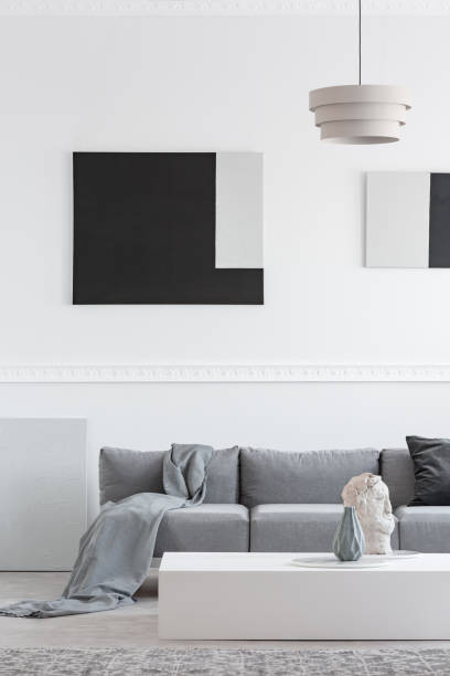 istock Grey blanket and black pillow on comfortable sofa in stylish living room interior 1146497873