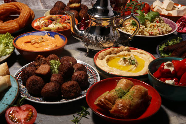 istock Middle eastern or arabic dishes and assorted meze, concrete rustic background. Falafel. Turkish Dessert Baklava with pistachio. Halal food. Lebanese cuisine 1146498348