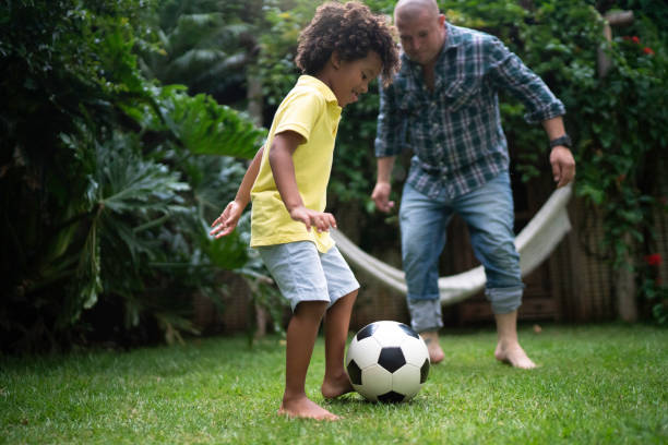 istock Father and son playing soccer in backyard 1146501920