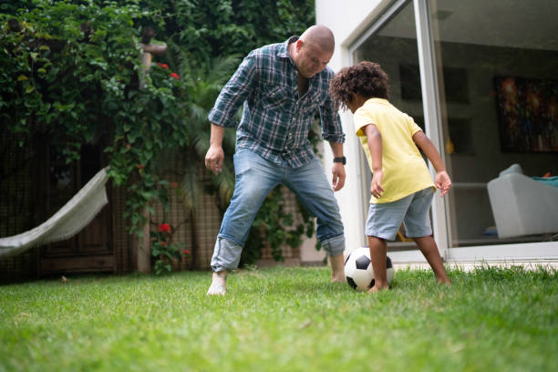 istock Father and son playing soccer in backyard 1146502063