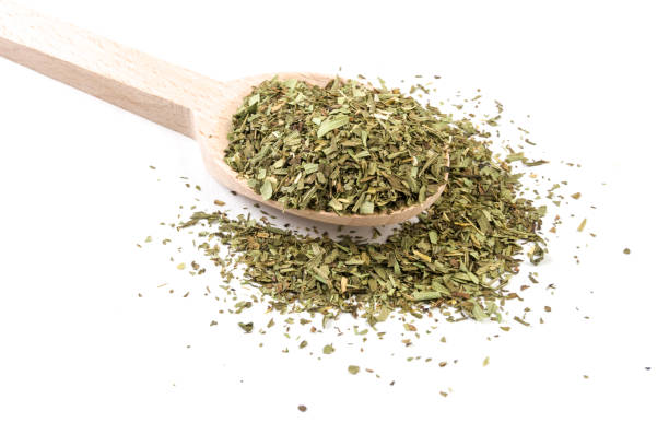 istock tarragon on wooden spoon on white background 1146502130