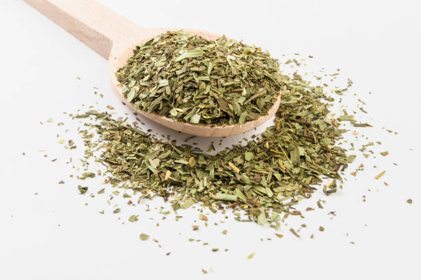 istock tarragon on wooden spoon on white background 1146502133