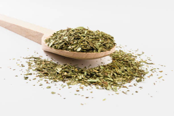 istock tarragon on wooden spoon on white background 1146502167