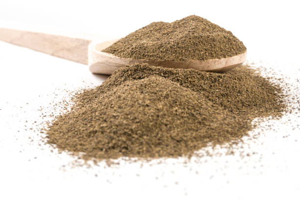 istock milled or ground black pepper on wooden spoon on white background 1146503862