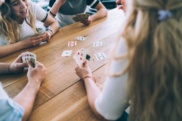 Family Playing Cards Cheerful Family Playing Cards friends playing cards stock pictures, royalty-free photos & images