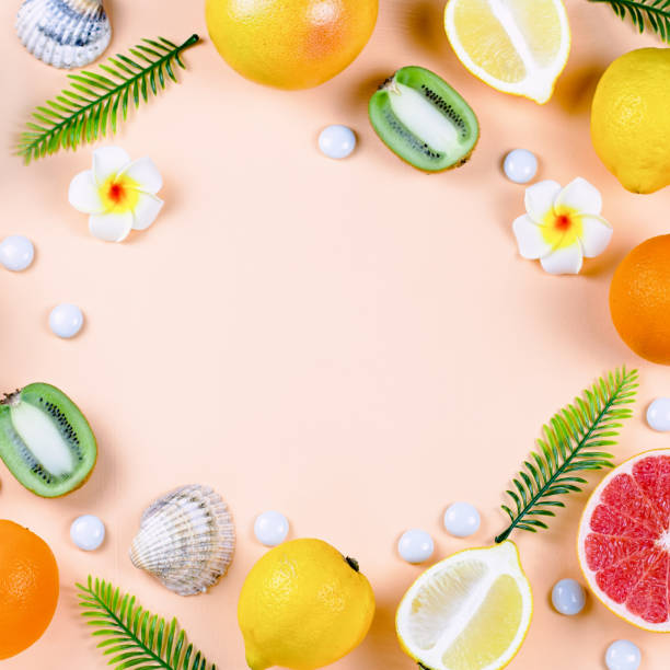 istock Summer tropical fruits frame on coral color background 1146505384