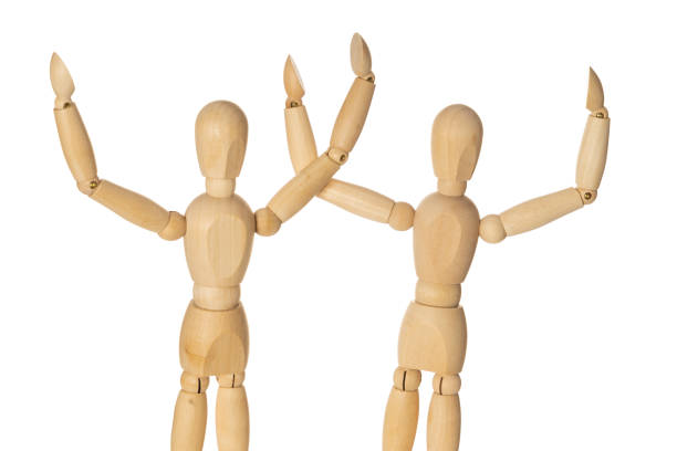 istock Two Wooden Mannequin Hands Up as Winners. Isolated White Background. 1146507645
