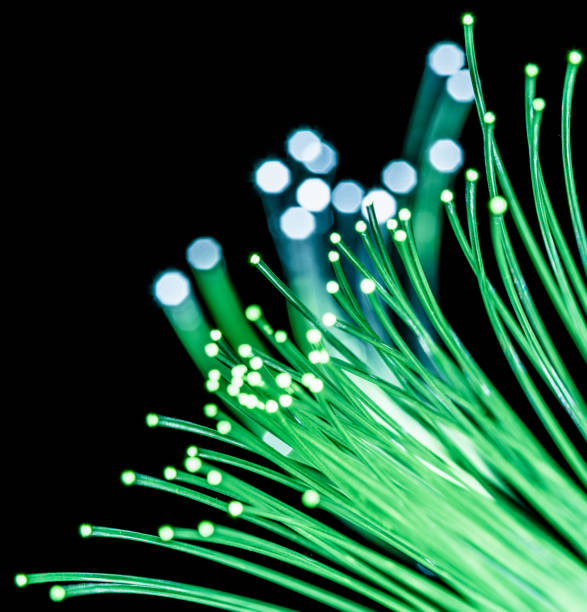 istock Bundle of optical fibers with green light. 1146508138