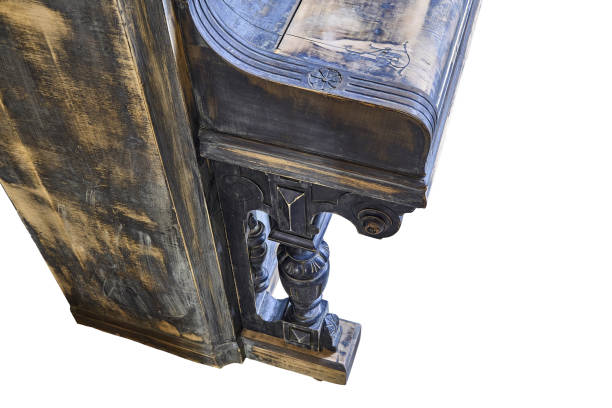 istock Old-fashioned antique ornamental piano with carved pillars. Before restoration 1146509421
