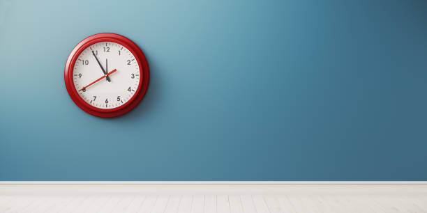istock Red Alarm Clock In Front of Blue Wall 1146511359