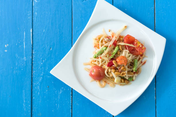 istock Thai Spicy papaya salad with tomato or Som Tam 1146512721