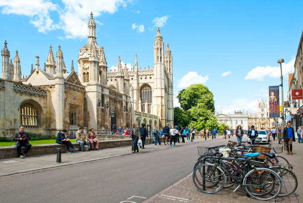 Many Bicycles and University of Cambridge CAMBRIDGE, ENGLAND - MAY 28, 2015: University of Cambridge cambridgeshire photos stock pictures, royalty-free photos & images