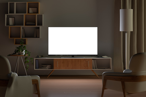Maqueta de TV en la sala de estar por la noche. Pantalla de TV, armario de televisión, sillas, estantería photo
