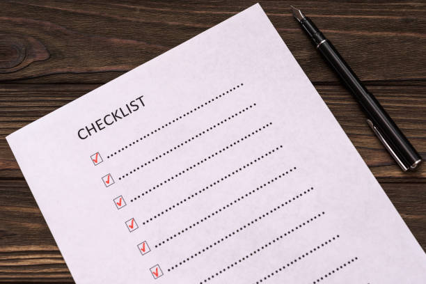 istock checklist, fountain pen on wooden table background. 1146518232