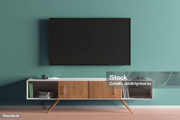 Tv Screen On The Turquoise Wall In Modern Living Room Stock Photo - Download Image Now