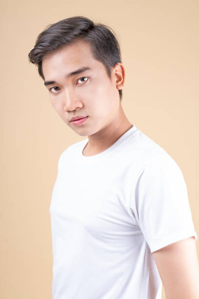 istock Asian young handsome guy looking into the camera in white shirt 1146518659