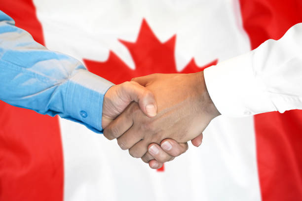 germanyhandshake en canadá bandera de fondo. - canada canadian flag business canadian culture fotografías e imágenes de stock
