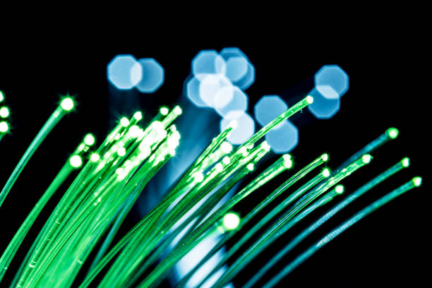 istock Bundle of optical fibers with green light. 1146518881