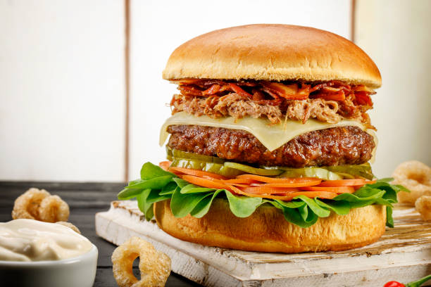 istock Handmade hamburger on wooden background with spices 1146520787