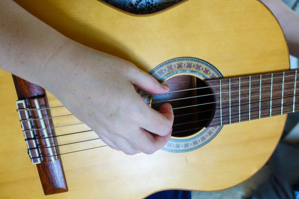 istock Female hand playing on acoustic guitar. Close-up. 1146521178