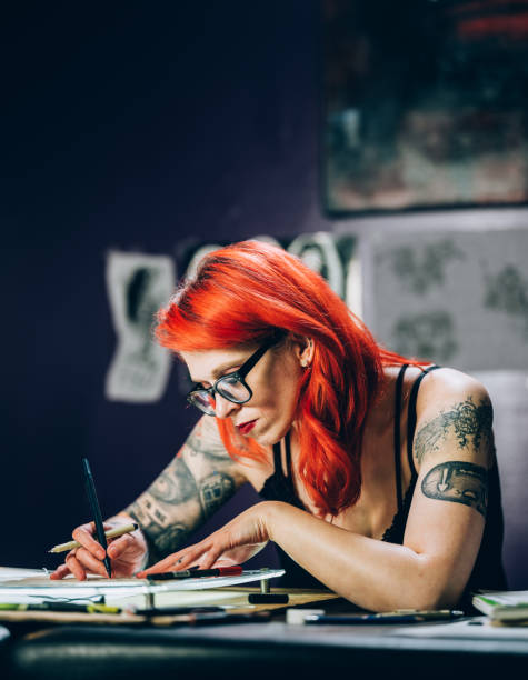 istock Tattoo artist drawing in her studio 1146521319