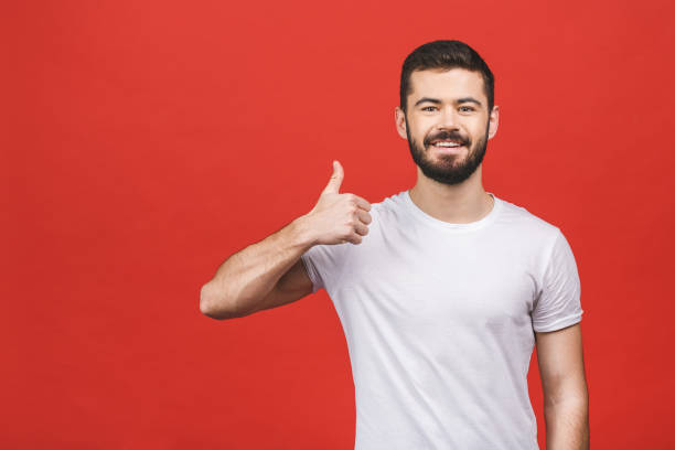 istock Happy handsome man showing thumbs up isolated over red background. 1146521530