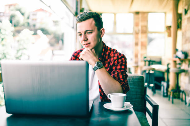 Handsome Male Hipster Enjoying Coffee And Social Media