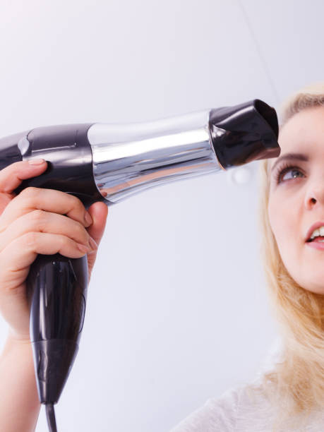istock Woman drying hair in bathroom 1146528419