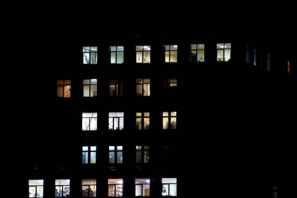 istock View of a night house with luminous windows, background 1146529651