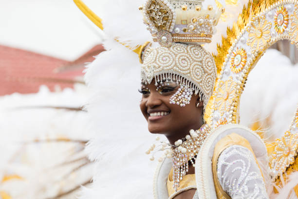 Peniche, Portugal - March 3, 2019: Mature woman participating in traditional carnival parade in Portugal, wearing colorful costume. Portuguese carnivals are celebrated in every town usually at the end of February. They symbolize end of the winter and beginning of the summer time. Parade goes trough the main street with loud music played and people having fun.