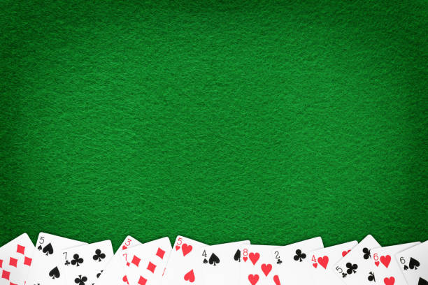 istock Green casino felt table with cards row template 1146530793