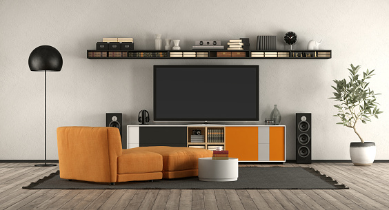 Modern living room with home cinema equipment. orange armchair and sideboard - 3d rendering
the room does not exist in reality, Property model is not necessary
