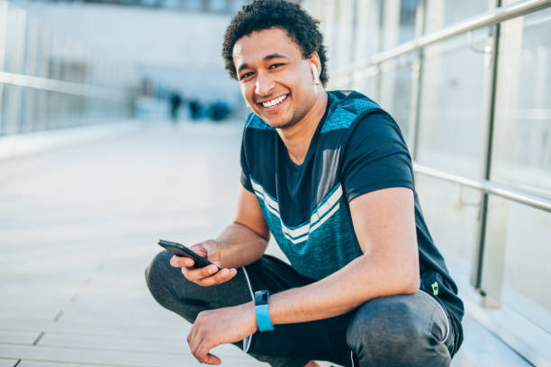 istock Smiling athlete with smart phone 1146531548