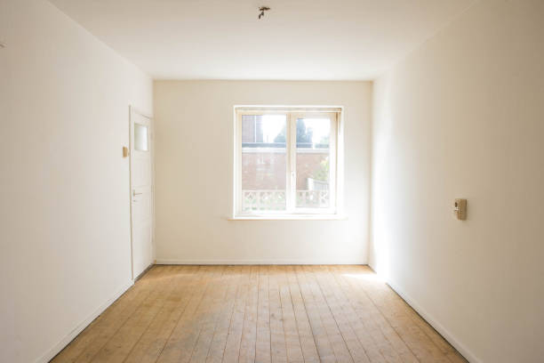 empty white room with wooden parquet floor before renovation stock photo