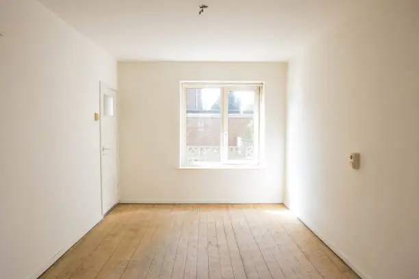 empty white room with wooden parquet floor before renovation old empty