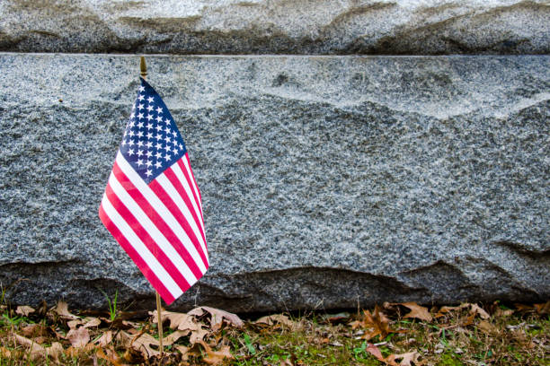 istock American flag at memorial stone 1146534014