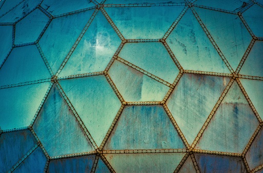 Blue futuristic grungy wall panels made of geometric shapes