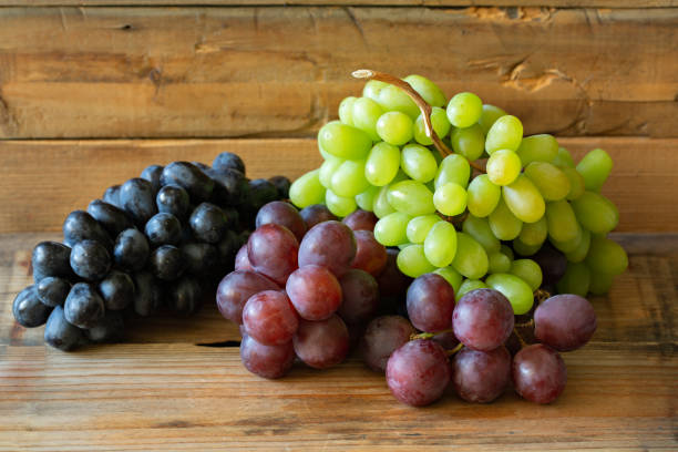 istock There different kinds of Grapes: green grape, red grape, dark grape on wooden background 1146539743
