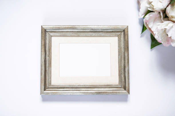 istock Blank wooden frame and peonies mockup 1146541577