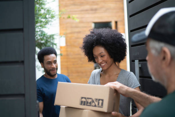 istock Courier delivering boxes to a young couple 1146541630