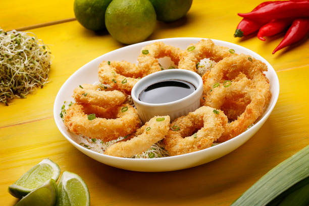 istock Squid fried in squid rings on wood background 1146542814