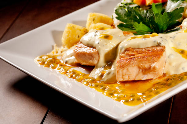 istock Salmon fillet with passion fruit sauce on wood background 1146543831