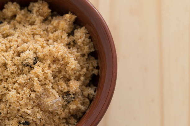 Farofa (crumbs). Brazilian Feijoada side dish on wooden background